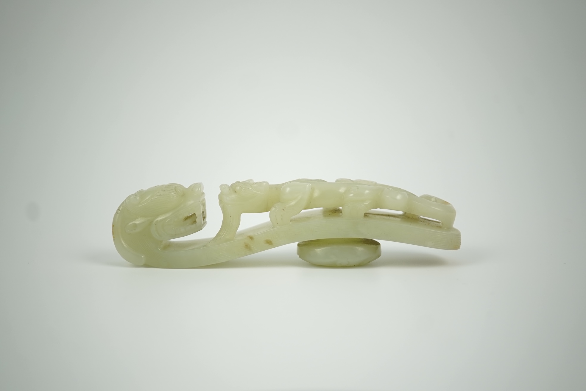 A Chinese pale celadon jade 'dragon' belt hook, 18th/19th century